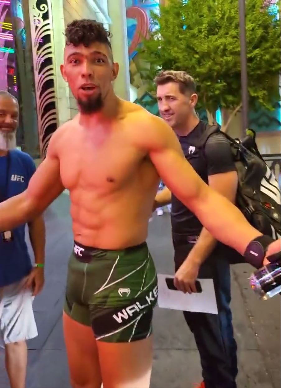 Johnny Walker kisses his KO opponent before he is THROWN AWAY from the arena at UFC 279 without shoes after winning fight