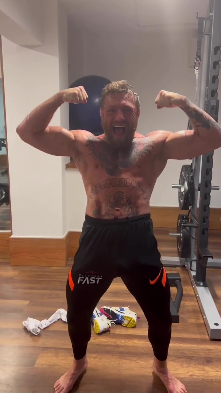 Conor McGregor is a terrifying topless UFC fighter. He clenches his jaws and shouts war cry.
