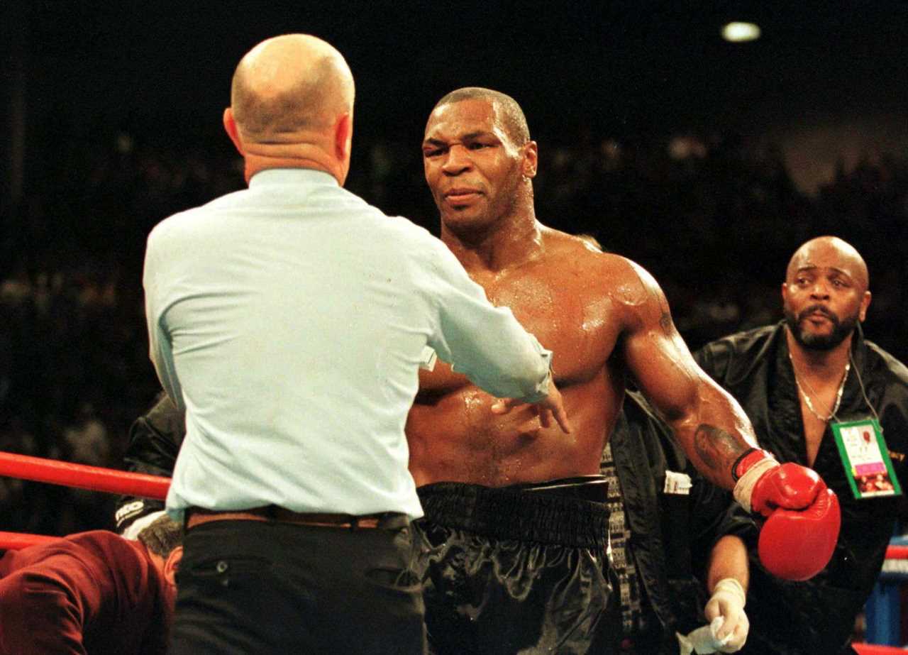Ref Mills Lane is hugged by Mike Tyson in a touching throwback snap, years after he was disqualified for biting Holyfield's ears off