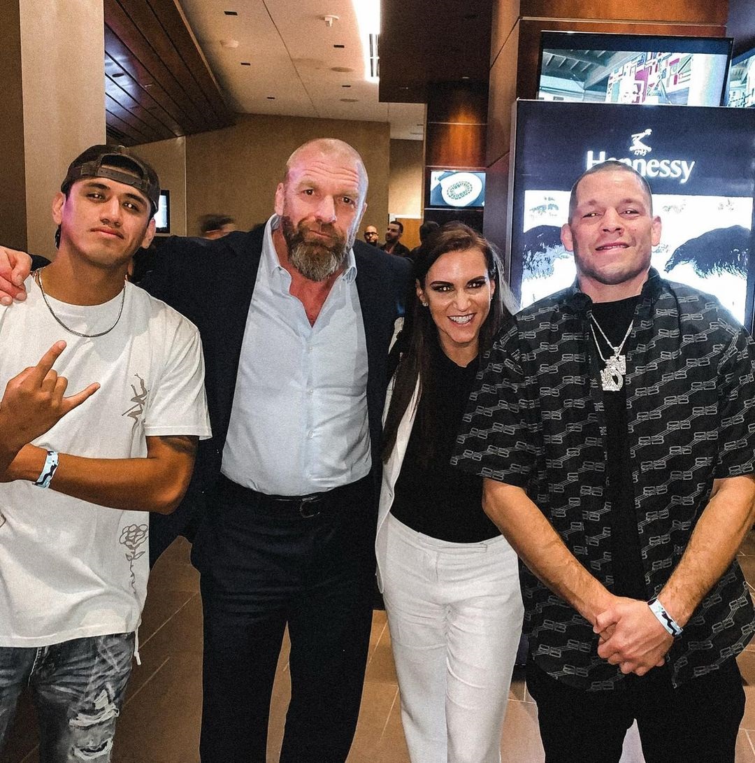 UFC star Nate Diaz teases a move to WWE. He is seen pictured with Triple H and Stephanie McMahon.