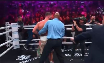 Caleb Plant is tackled by referee after he did a 'digging grave celebration' following the brutal Anthony Dirrell KO