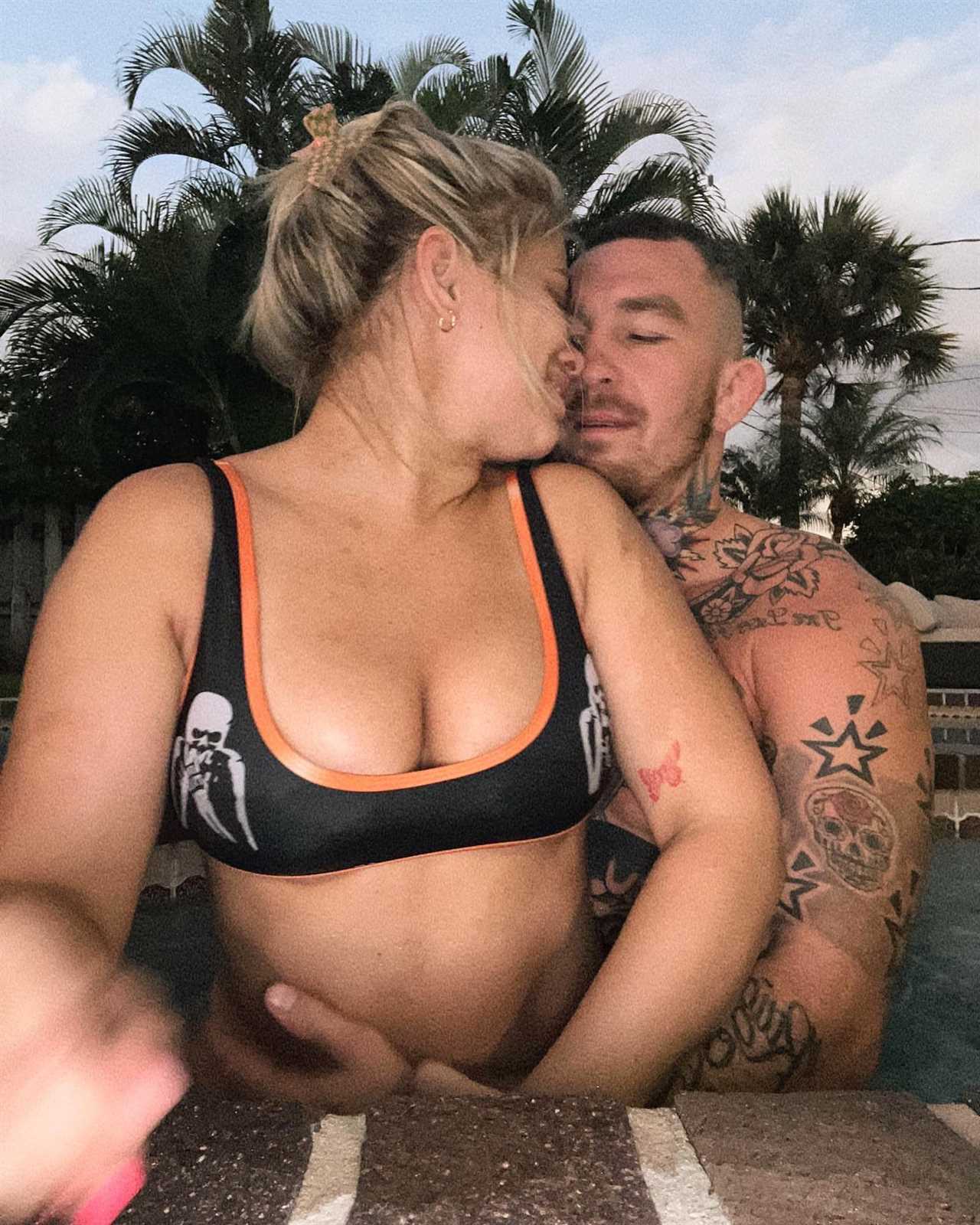 Paige VanZant, ex-UFC star, sends fans wild by her busty display while she packs on the PDA in swimming pool with her husband
