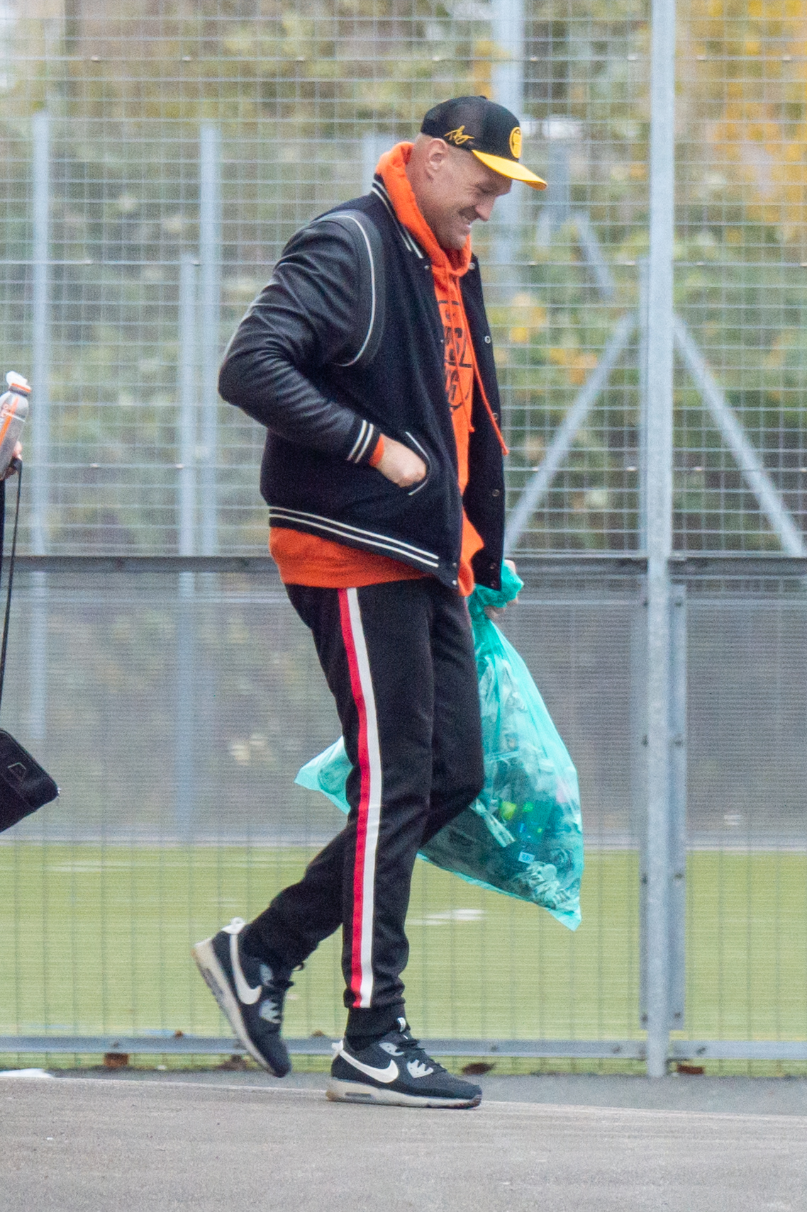 Tyson Fury cleans up the trash as he leaves Morecambe gym in preparation for Derek Chisora fight