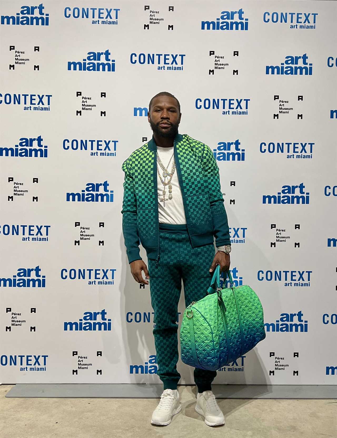 Floyd Mayweather rocked a PS3,200 reversible Louis Vuitton ensemble with matching bag at an art exhibition in Miami