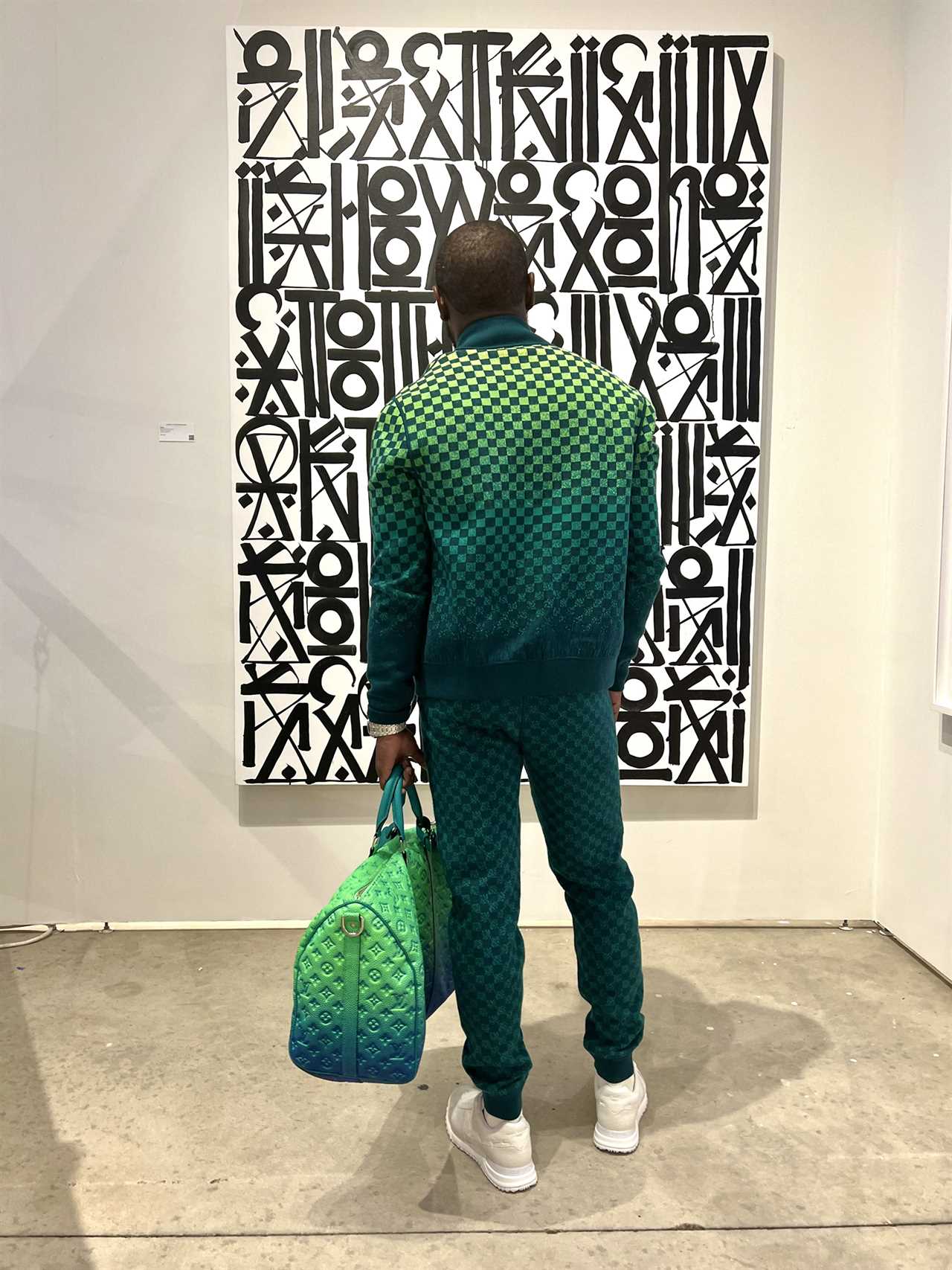 Floyd Mayweather rocked a PS3,200 reversible Louis Vuitton ensemble with matching bag at an art exhibition in Miami