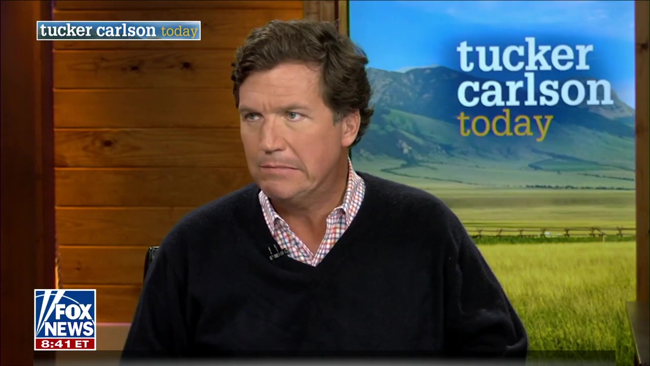 Tucker Carlson is watching stony-faced Mike Tyson making nervous laughter as he claims he 'wanted' to kill his opponents