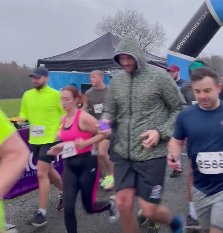 Pregnant Molly Mae cheers on boyfriend Tommy Fury and Tyson Fury during a fun run through torrential rain, before digging into big fry up