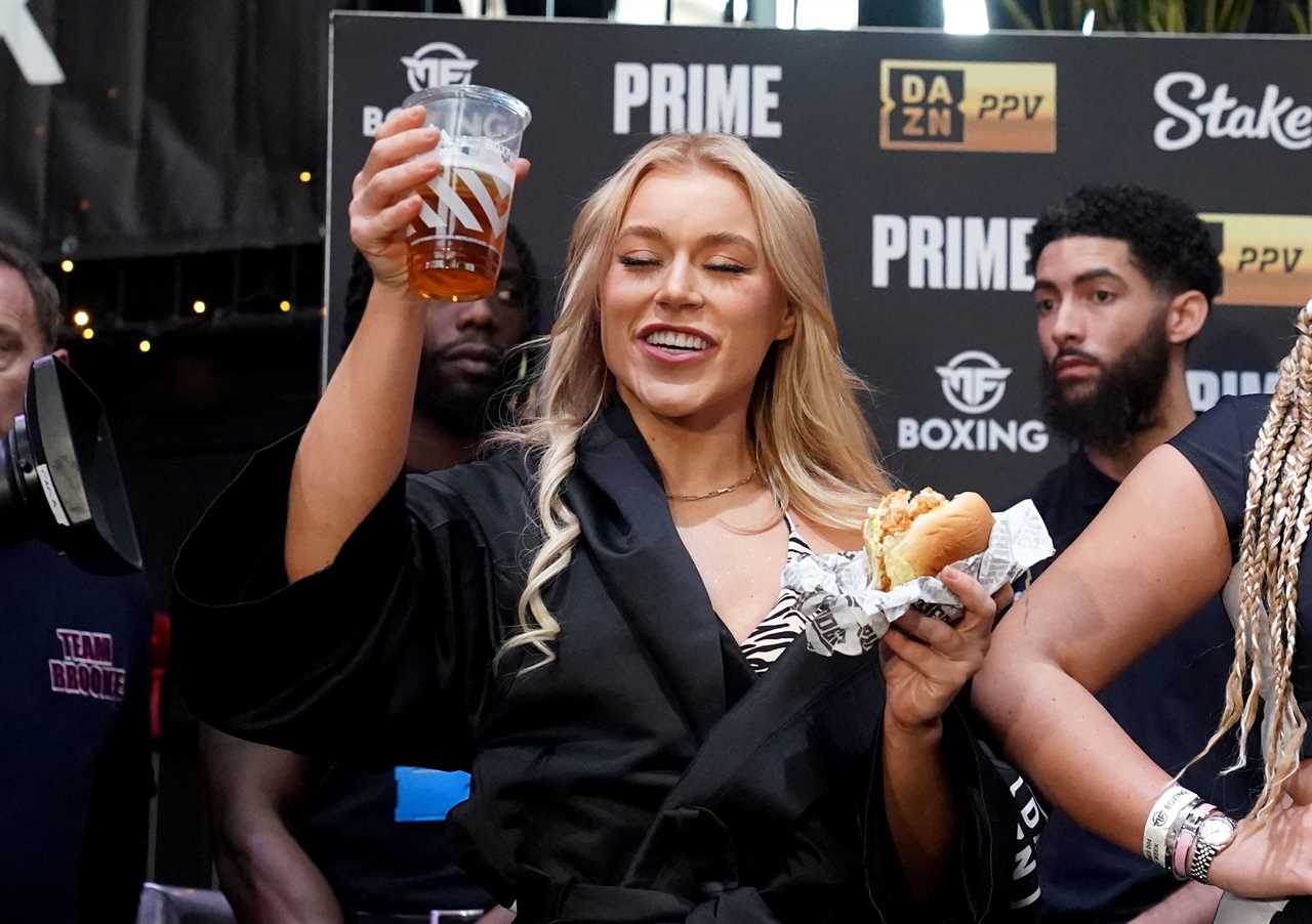Elle Brooke, a former boxer for OnlyFans, wears a bikini with zebra print as she enjoys a beer and burger at weigh in