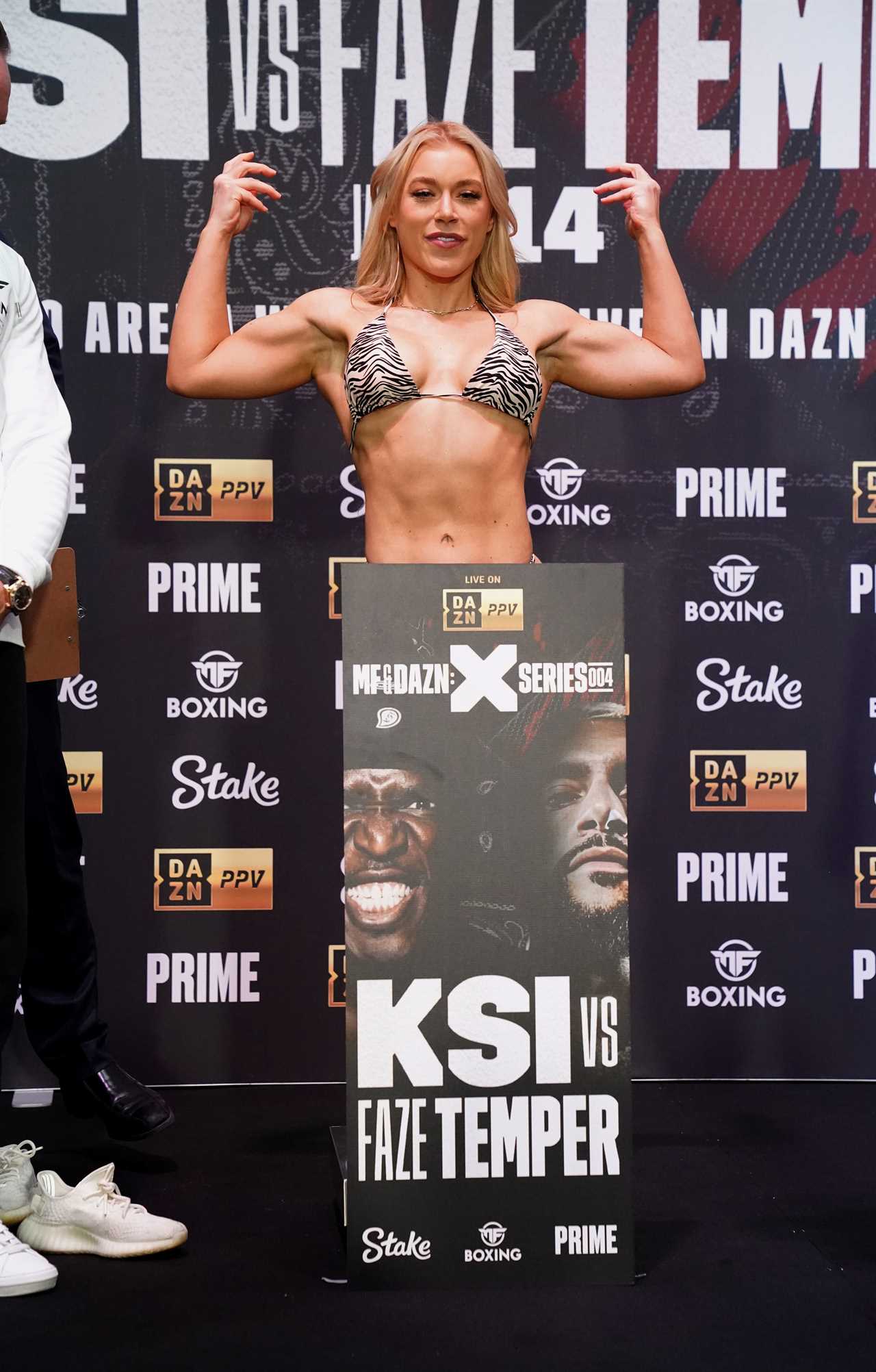 Elle Brooke, a former boxer for OnlyFans, wears a bikini with zebra print as she enjoys a beer and burger at weigh in