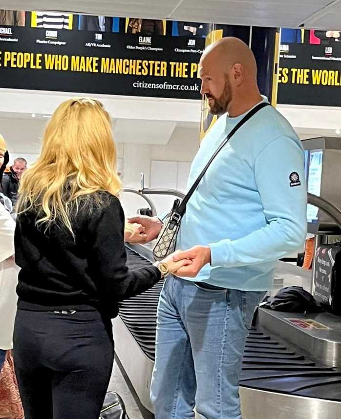 Tyson Fury embraces his wife Paris at the airport after he returns from Tenerife on a family holiday. He is preparing for Oleksandr Usyk's fight