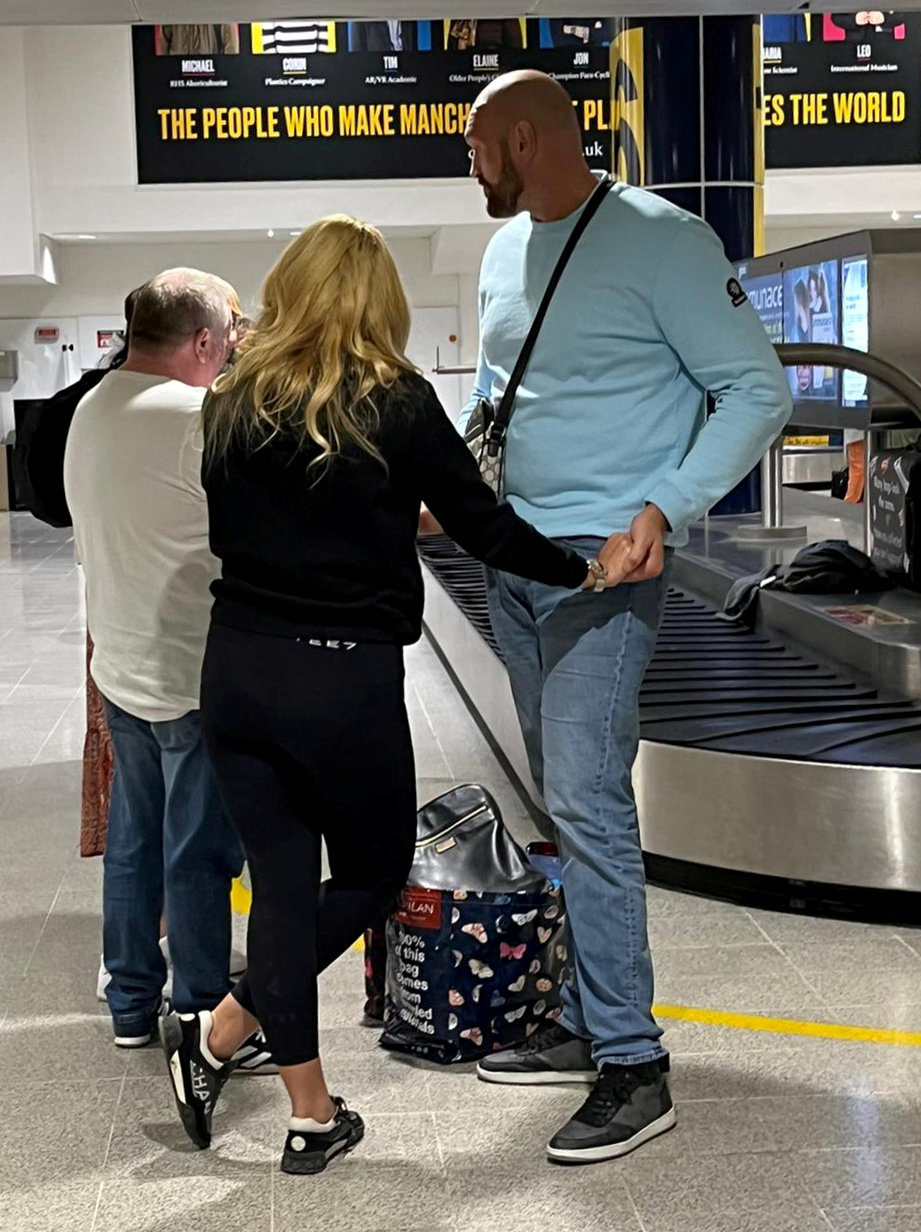 Tyson Fury embraces his wife Paris at the airport after he returns from Tenerife on a family holiday. He is preparing for Oleksandr Usyk's fight