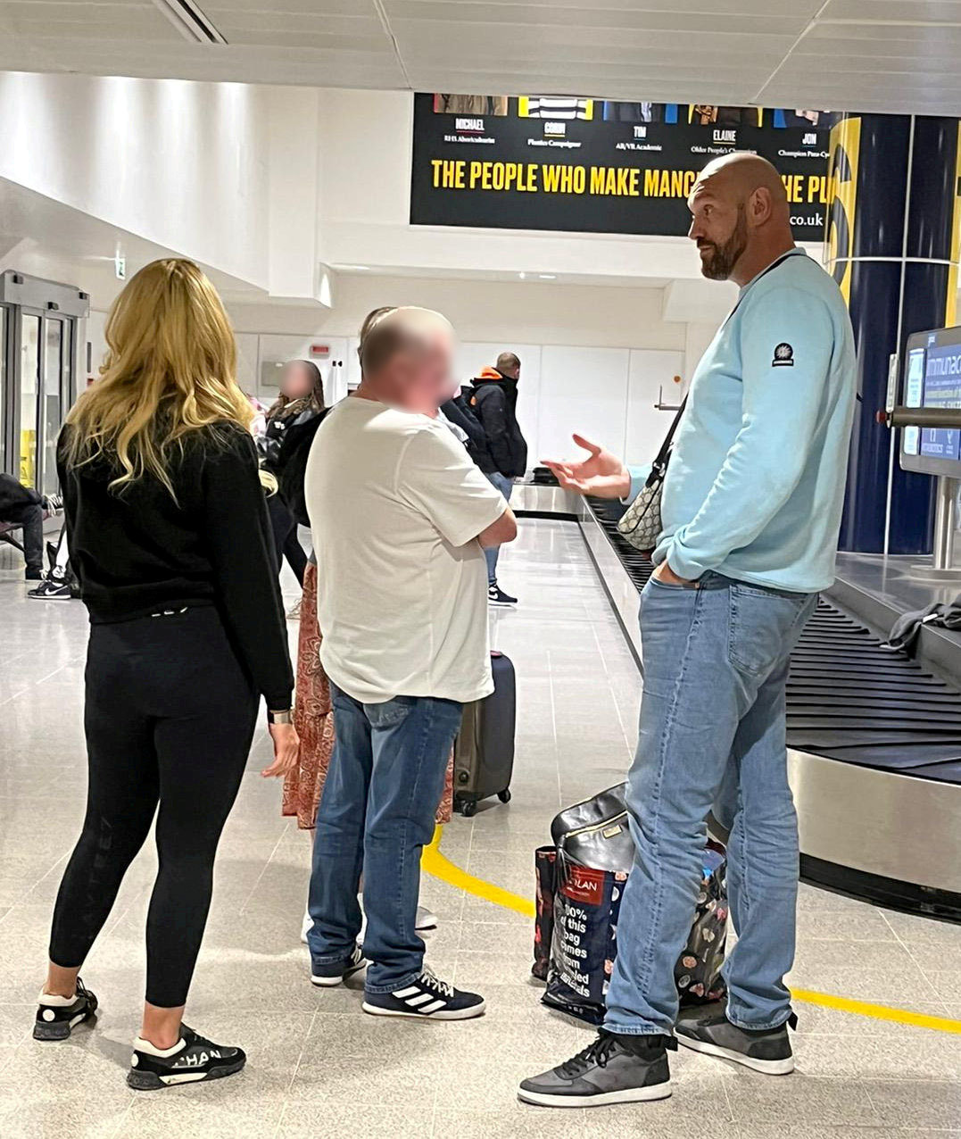 Tyson Fury embraces his wife Paris at the airport after he returns from Tenerife on a family holiday. He is preparing for Oleksandr Usyk's fight