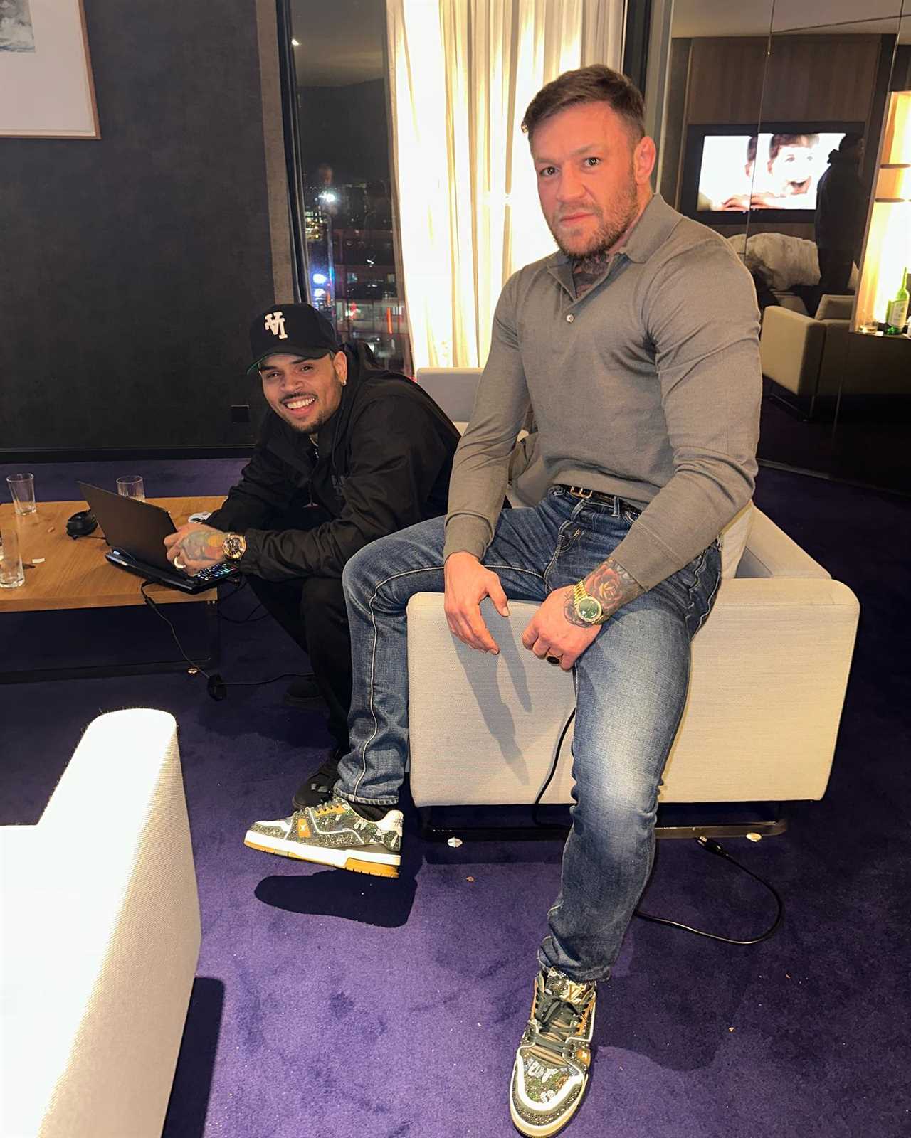 Conor McGregor, topless UFC fighter, celebrates with Chris Brown at a 'proper mad evening' in Dublin