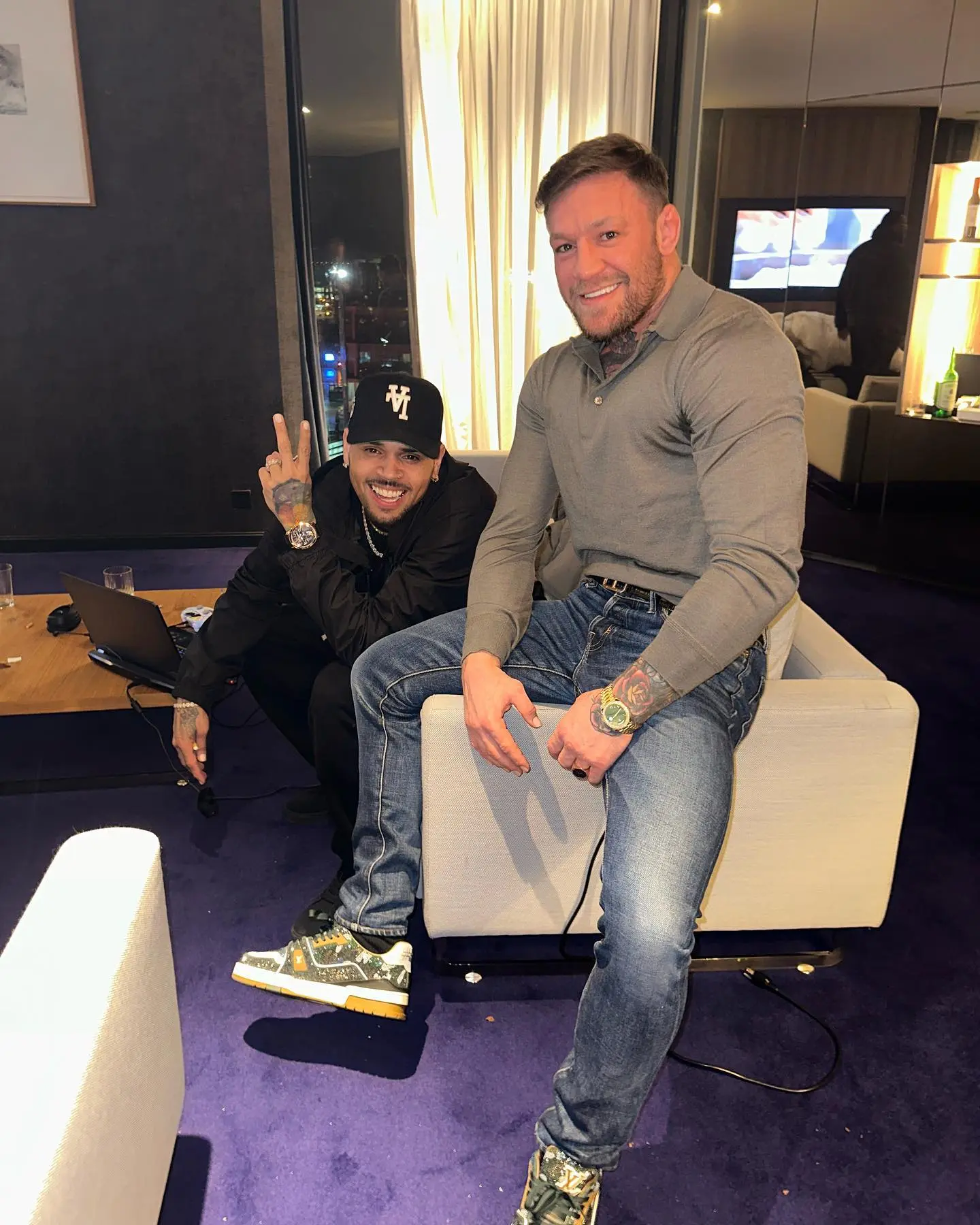 Conor McGregor, topless UFC fighter, celebrates with Chris Brown at a 'proper mad evening' in Dublin