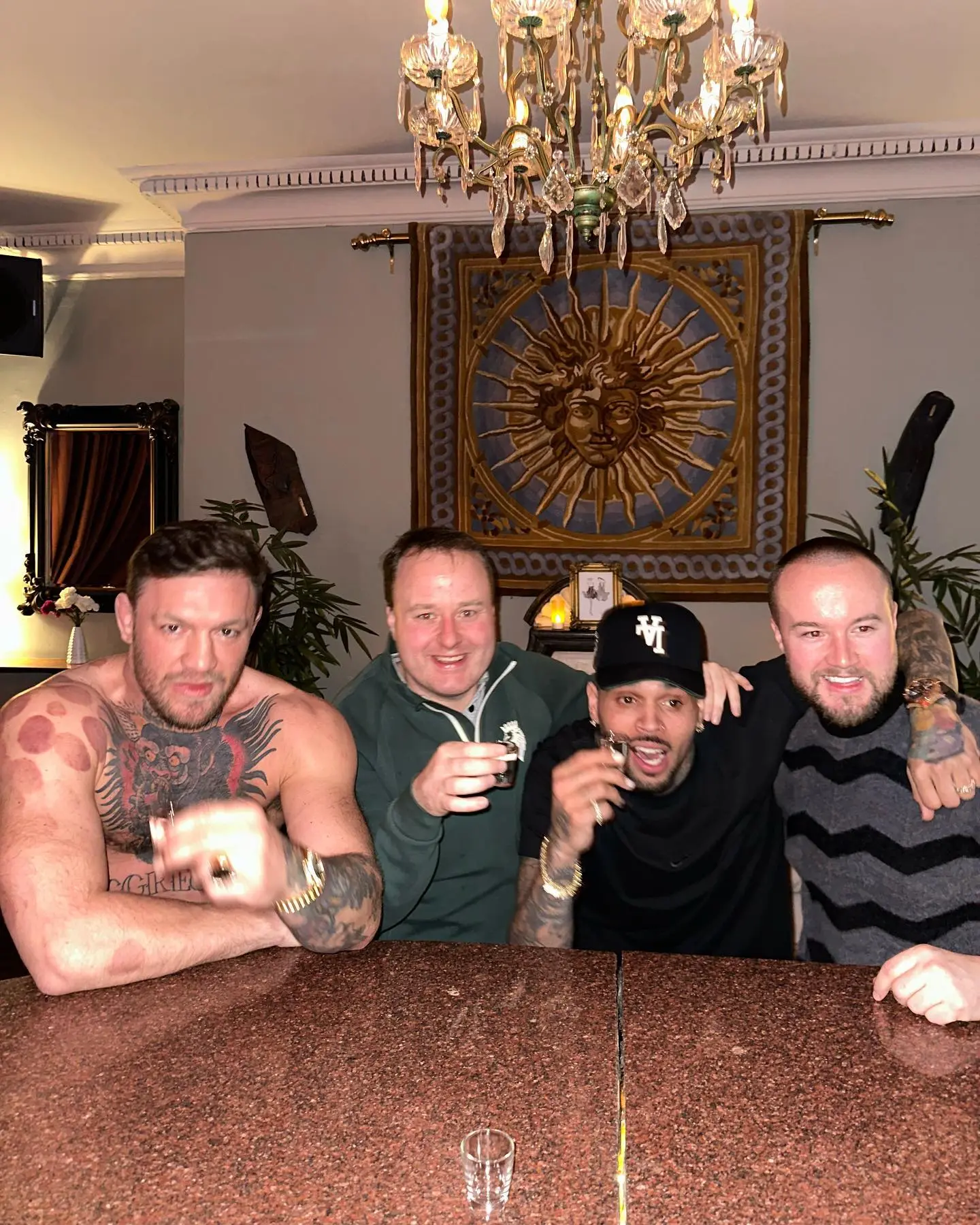 Conor McGregor, topless UFC fighter, celebrates with Chris Brown at a 'proper mad evening' in Dublin