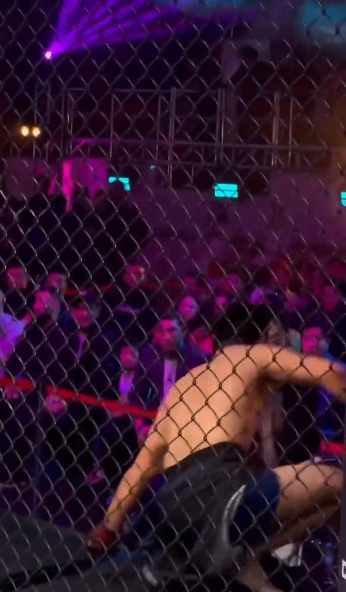 That would be me - Watch the incredible moment Teymur Zhaparov, MMA Fighter, falls off the top of his cage.