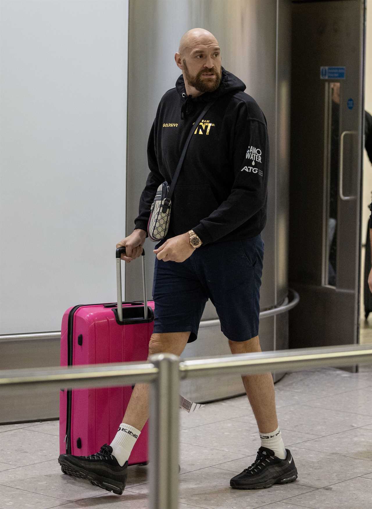 After a huge win over Jake Paul, Bruised Tommy Fury beams when he touches down at Heathrow together with dad John and brother Tyson.