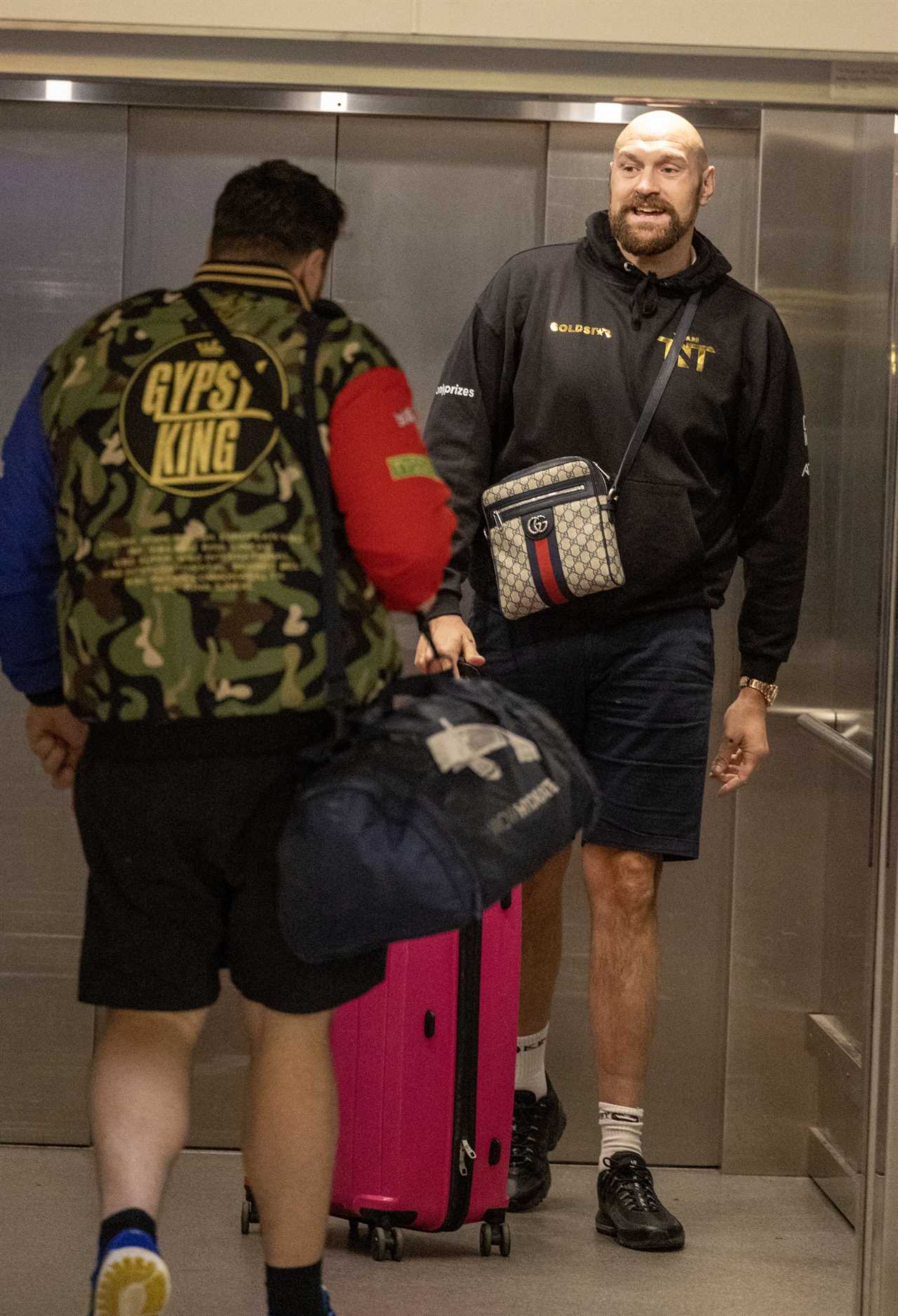 After a huge win over Jake Paul, Bruised Tommy Fury beams when he touches down at Heathrow together with dad John and brother Tyson.