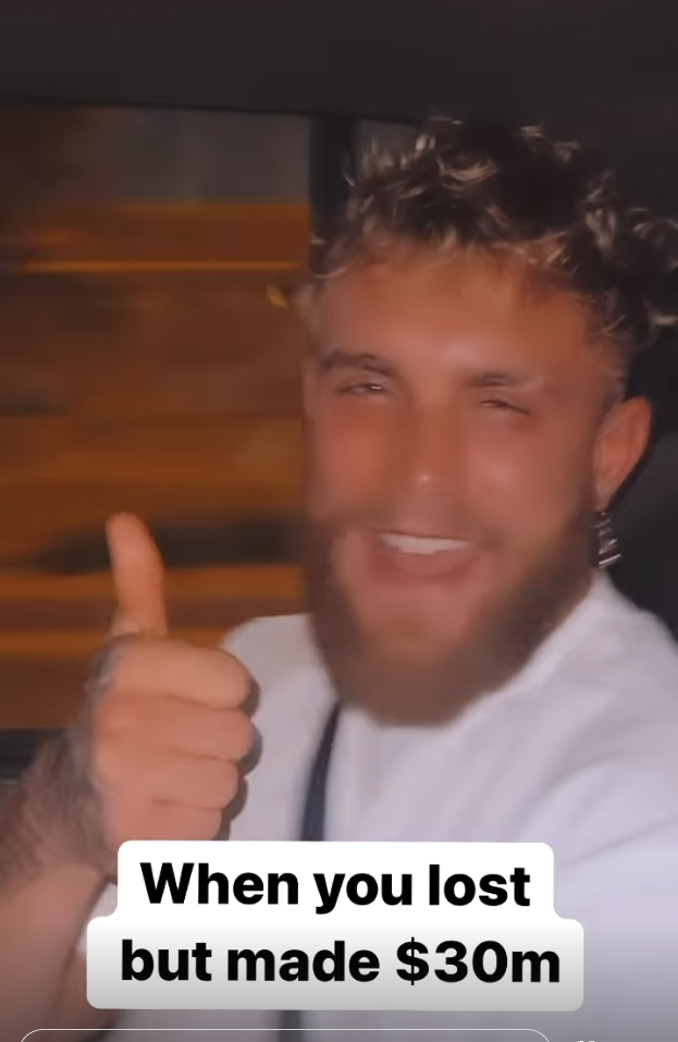 Jake Paul celebrates after he announces that despite Tommy Fury's defeat, he has made a huge eight-figure amount
