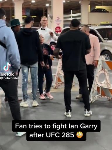 In a bizarre scene, watch as a random fan tries to fight Ian Garry backstage at UFC 285