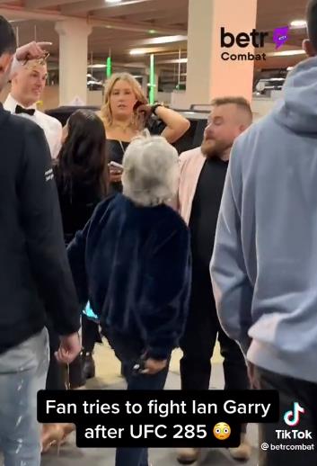 In a bizarre scene, watch as a random fan tries to fight Ian Garry backstage at UFC 285