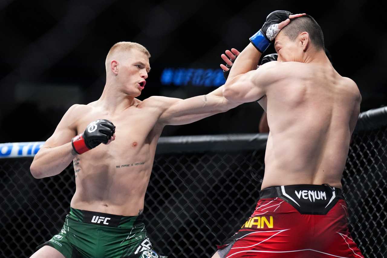 In a bizarre scene, watch as a random fan tries to fight Ian Garry backstage at UFC 285