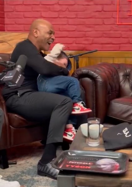 Mike Tyson takes on Hasbulla. He holds him in his arms, and then bites his ear.