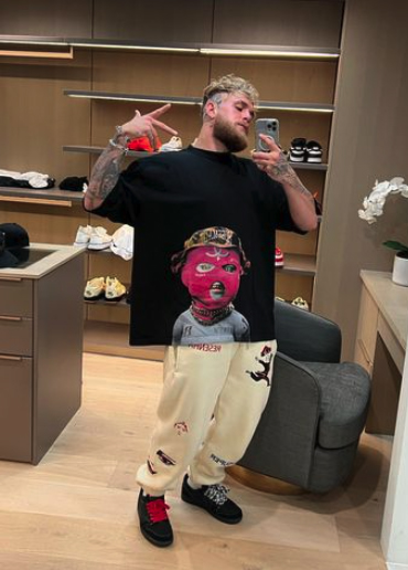 Jake Paul displays a brand new collection of tattoos, including a full leg sleeve featuring an angel and a massive tiger on the foot.