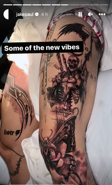 Jake Paul displays a brand new collection of tattoos, including a full leg sleeve featuring an angel and a massive tiger on the foot.