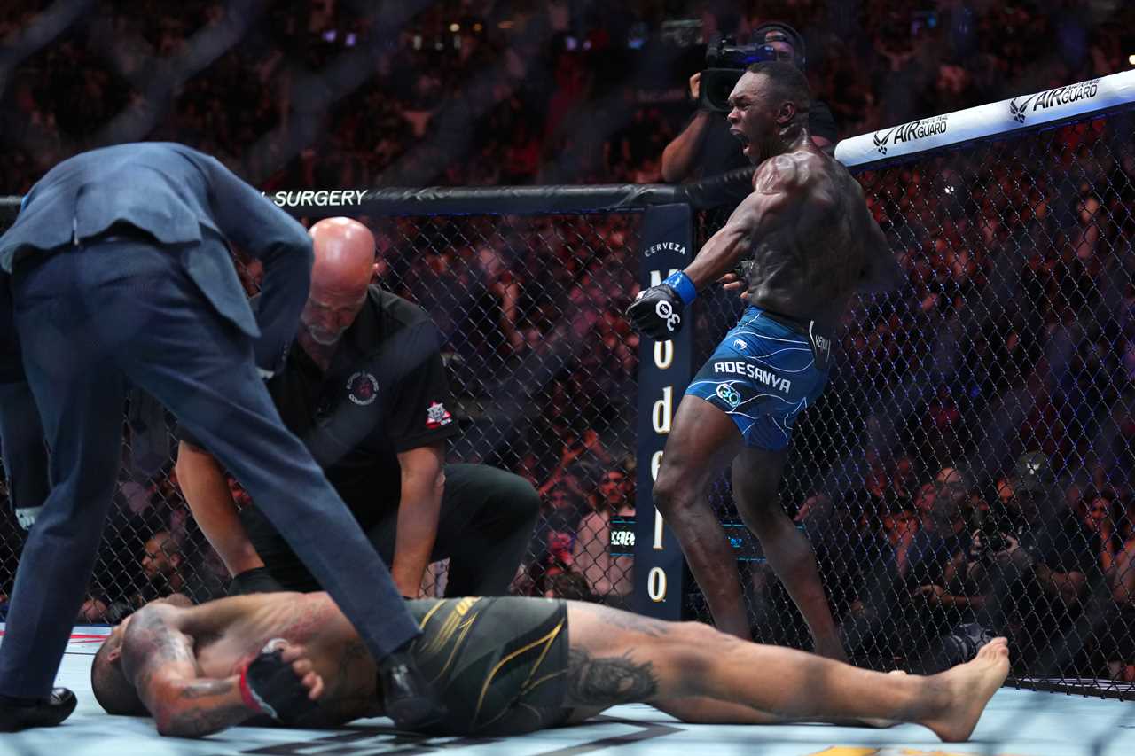 MIAMI, FLORIDA - APRIL 08: Israel Adesanya of Nigeria reacts after knocking out Alex Pereira of Brazil in the UFC middleweight championship fight during the UFC 287 event at Kaseya Center on April 08, 2023 in Miami, Florida. (Photo by Cooper Neill/Zuffa LLC via Getty Images)