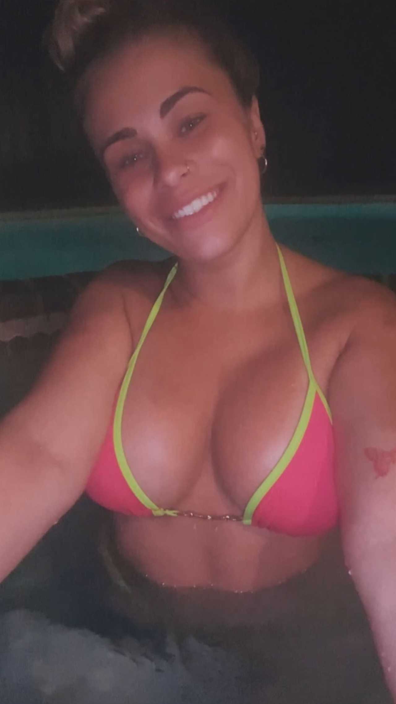Paige VanZant, former UFC star, poses in a bikini while in the hot tub.
