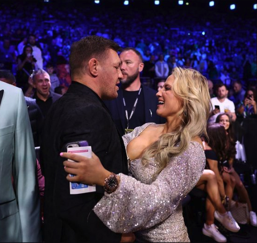 Ebanie bridges looks stunning in a low-cut dress while she fights with Conor McGregor.