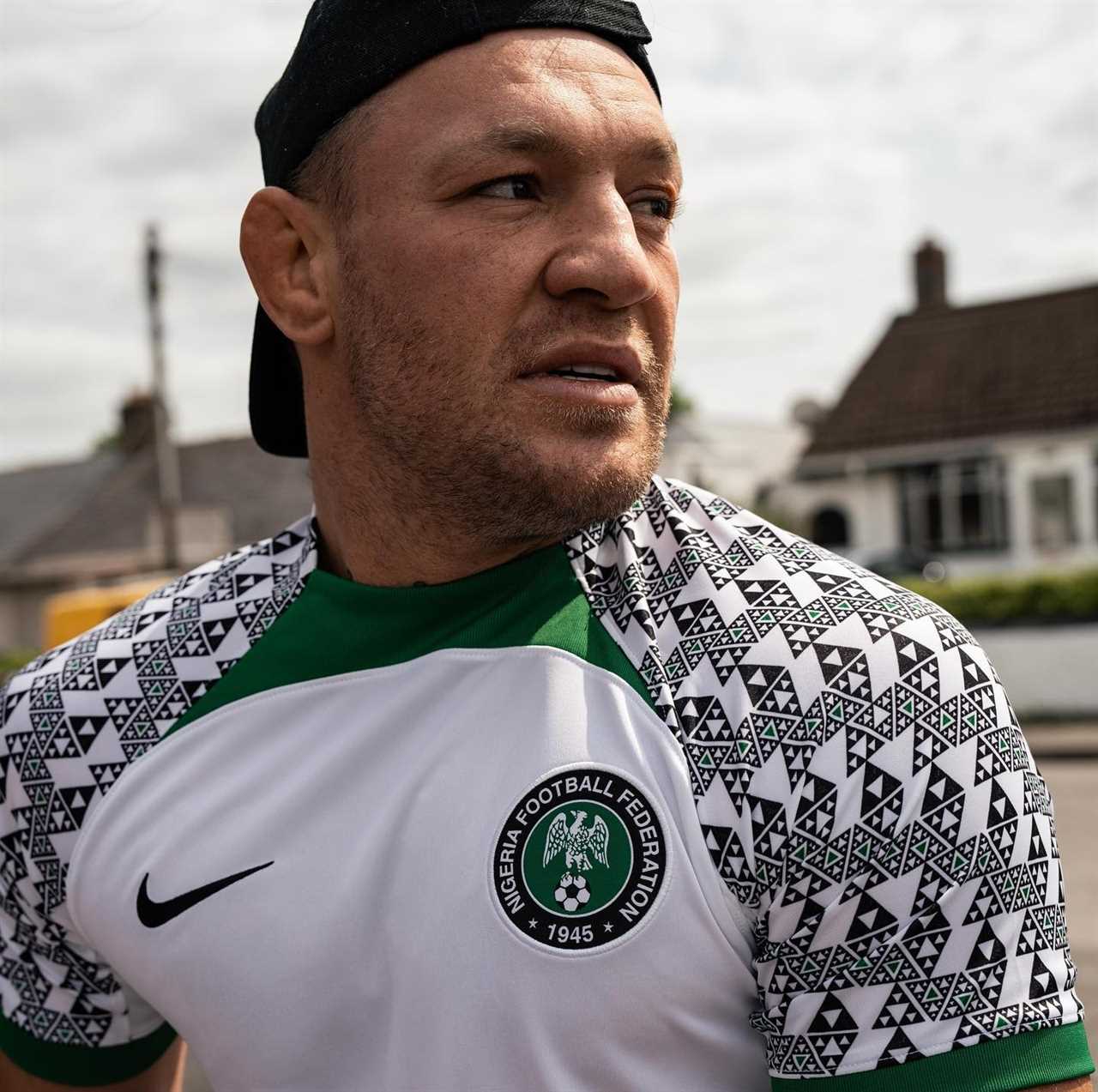 Conor McGregor gets back on his bicycle after he was hit by a car while cycling in Nigeria kit, then takes a dip in the ocean