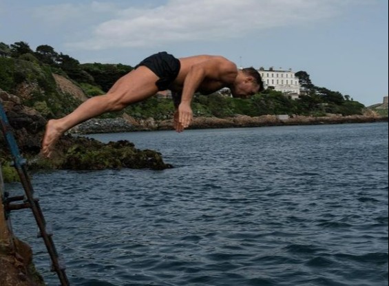 Conor McGregor gets back on his bicycle after he was hit by a car while cycling in Nigeria kit, then takes a dip in the ocean