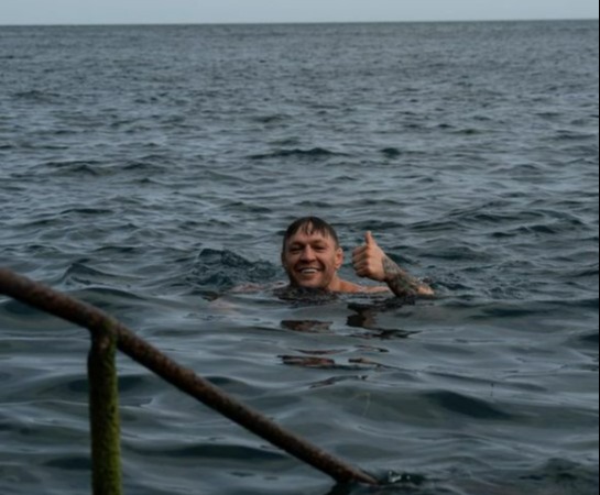 Conor McGregor gets back on his bicycle after he was hit by a car while cycling in Nigeria kit, then takes a dip in the ocean