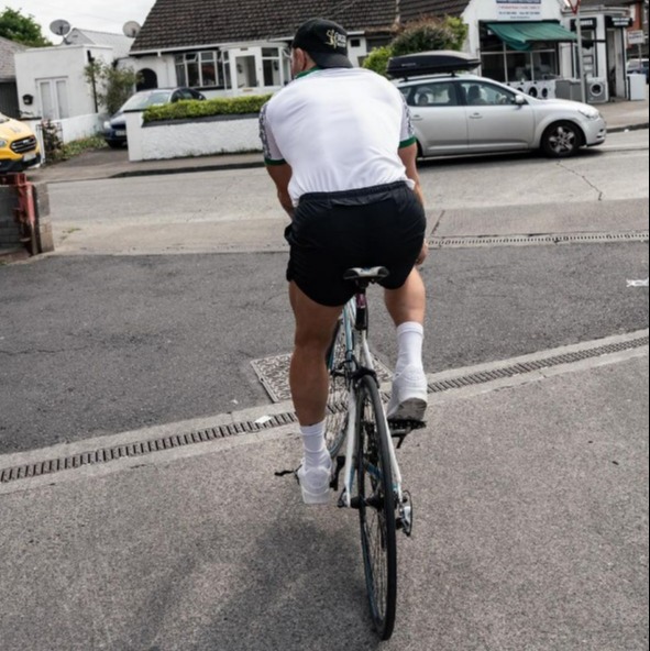 Conor McGregor gets back on his bicycle after he was hit by a car while cycling in Nigeria kit, then takes a dip in the ocean