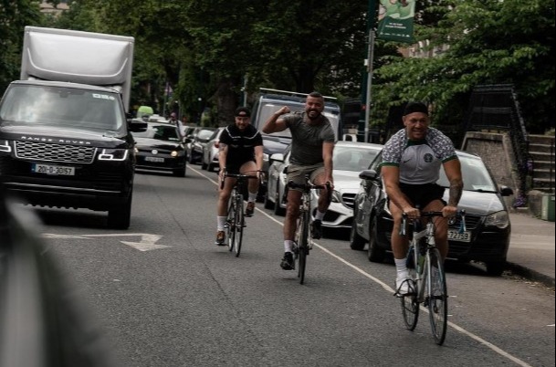 Conor McGregor gets back on his bicycle after he was hit by a car while cycling in Nigeria kit, then takes a dip in the ocean