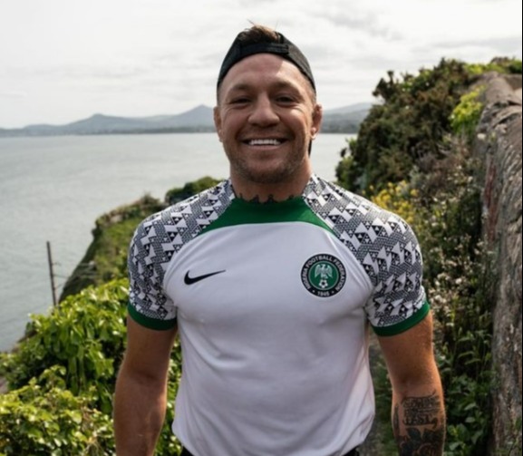 Conor McGregor gets back on his bicycle after he was hit by a car while cycling in Nigeria kit, then takes a dip in the ocean