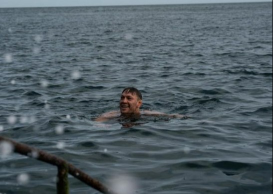 Conor McGregor gets back on his bicycle after he was hit by a car while cycling in Nigeria kit, then takes a dip in the ocean