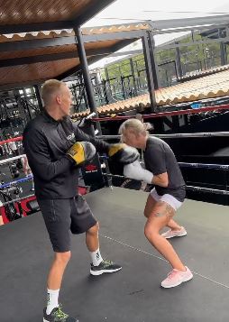 MMA and OnlyFans' star reveals that she is 'working hard, but playing even harder' before slamming trolls in a cheeky holiday message