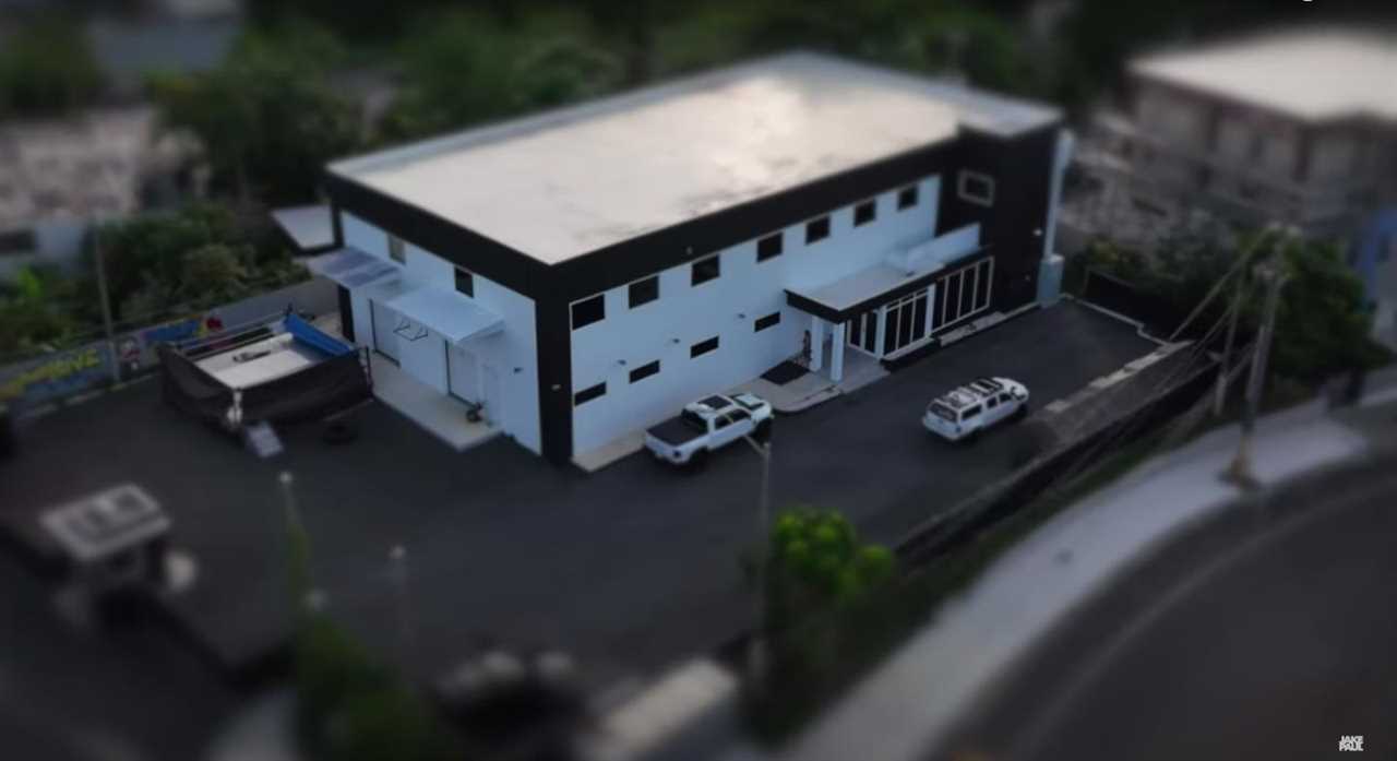 The two-story warehouse gym of Jake and Logan Paul in Puerto Rico, built for $4 million with a boxing ring and weights.