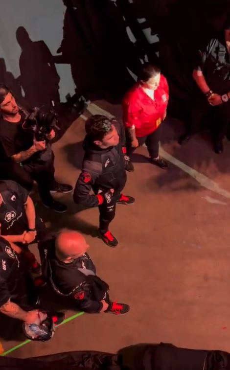 UFC 289 spectators almost fall on fighter doing octagon walking as railing collapses.