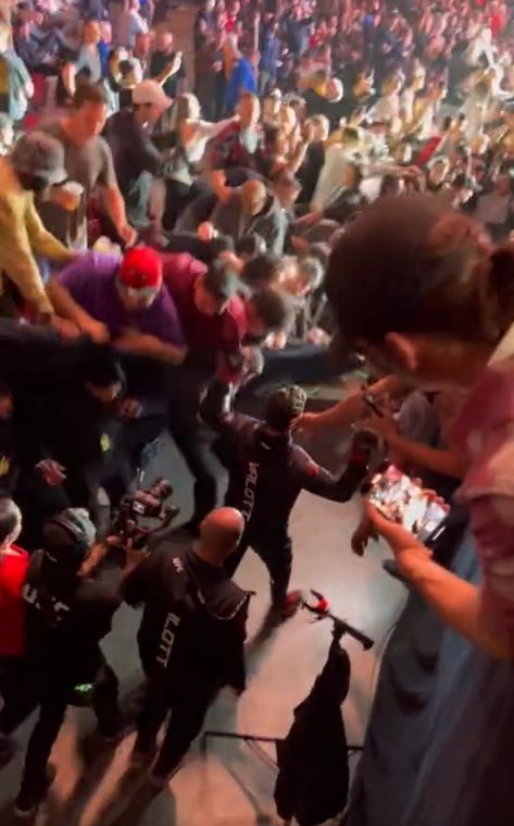 UFC 289 spectators almost fall on fighter doing octagon walking as railing collapses.