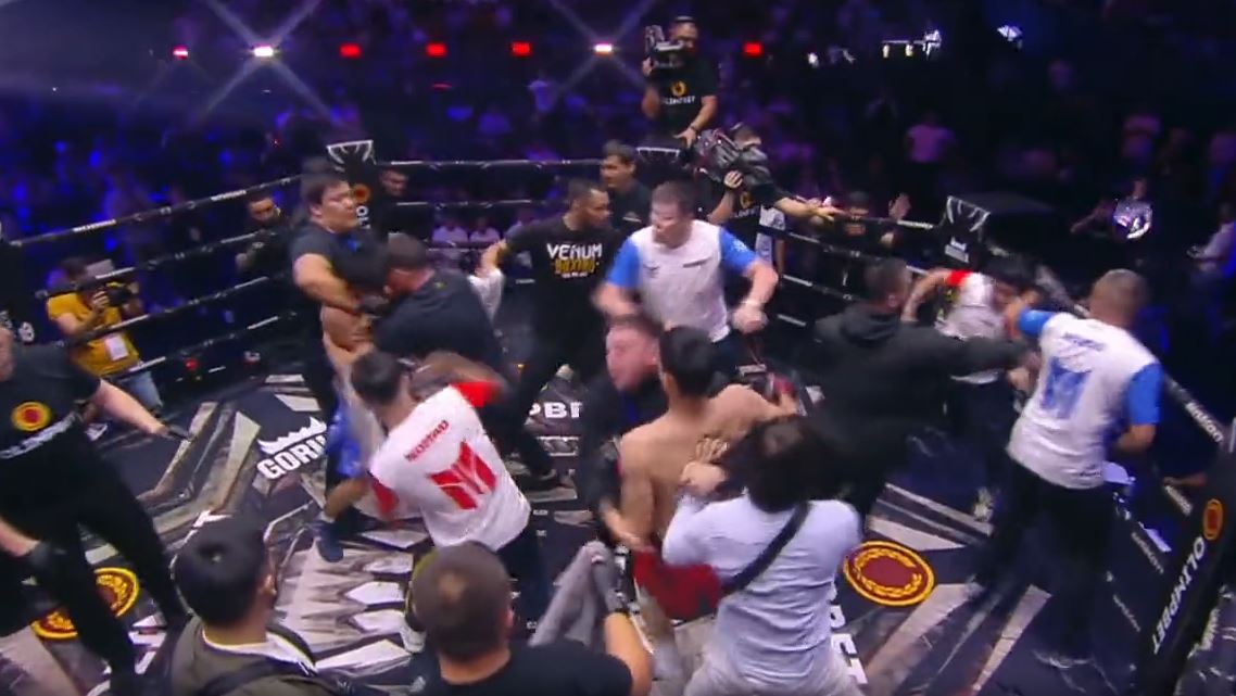 After MMA match, two teams start a shocking brawl. They throw punches and kicks.