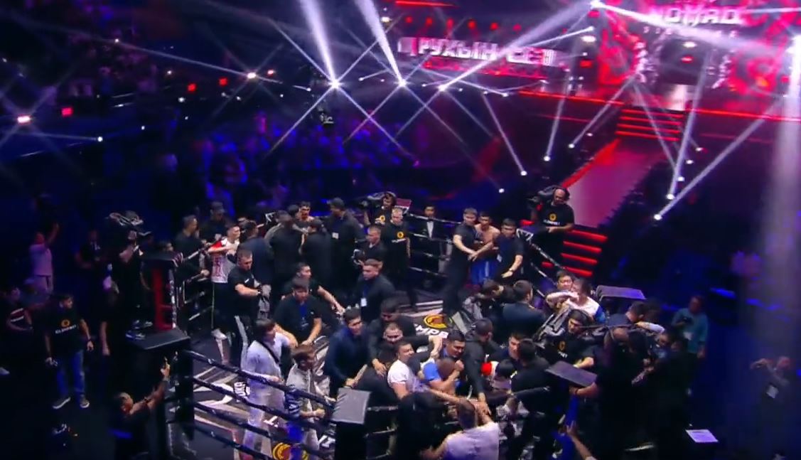 After MMA match, two teams start a shocking brawl. They throw punches and kicks.