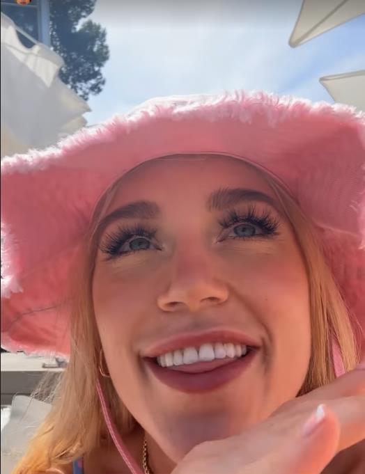 Elle Brooke in Magaluf relaxes and laughs as her boxer friend is'started'