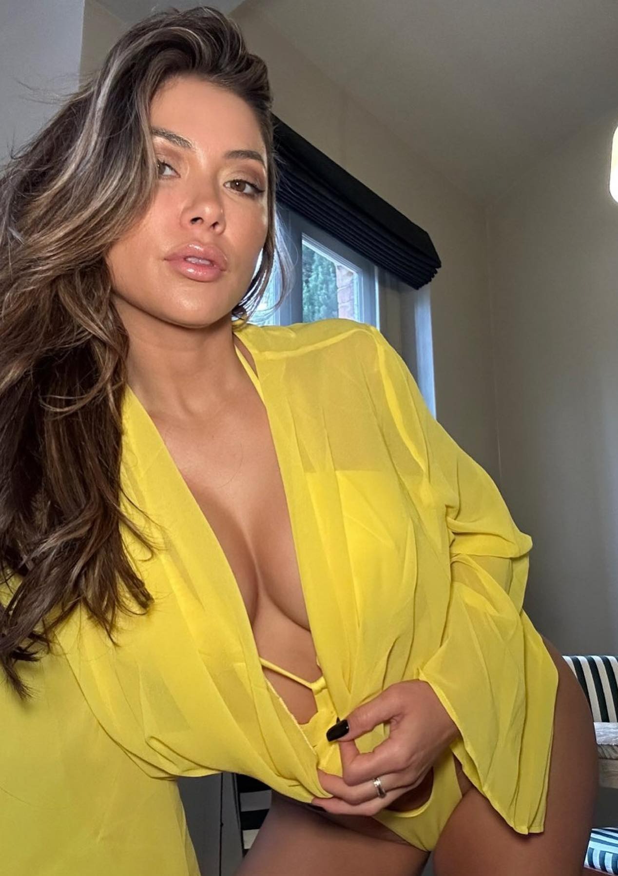 Fans exclaim'mama's still got it' when sexy UFC Octagon girl Arianny Celeste almost bursts from her blue bikini