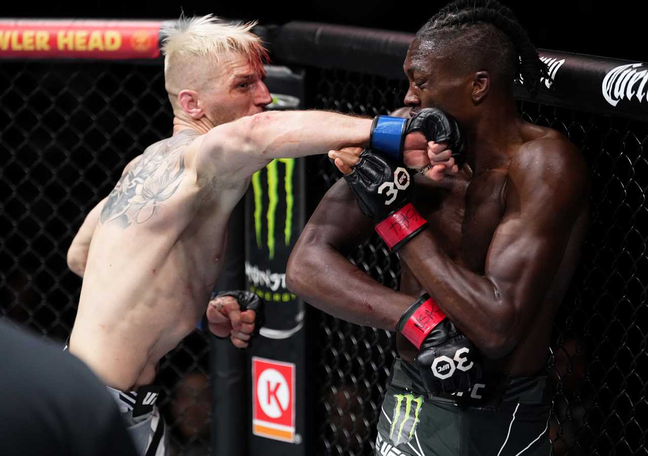 UFC star with a bloodied arm suffers horrific head injury and a broken arm, but still smiles.