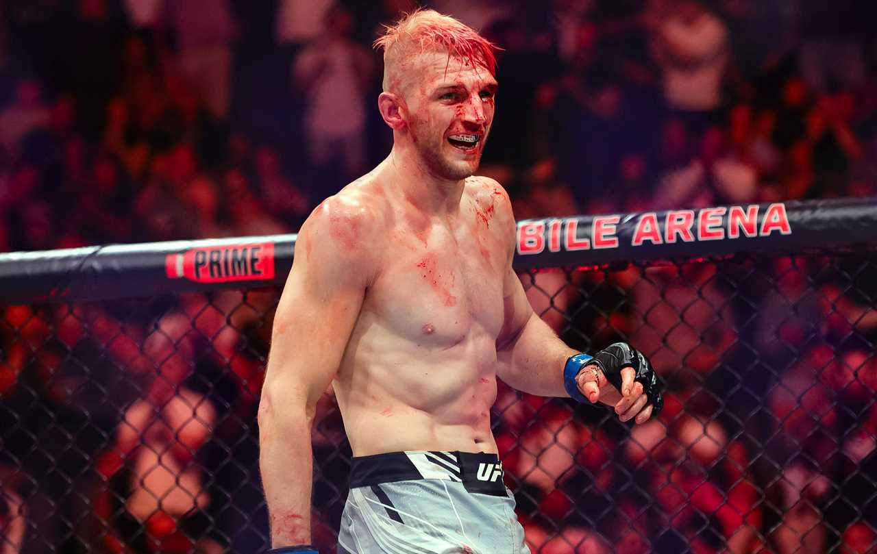 UFC star with a bloodied arm suffers horrific head injury and a broken arm, but still smiles.