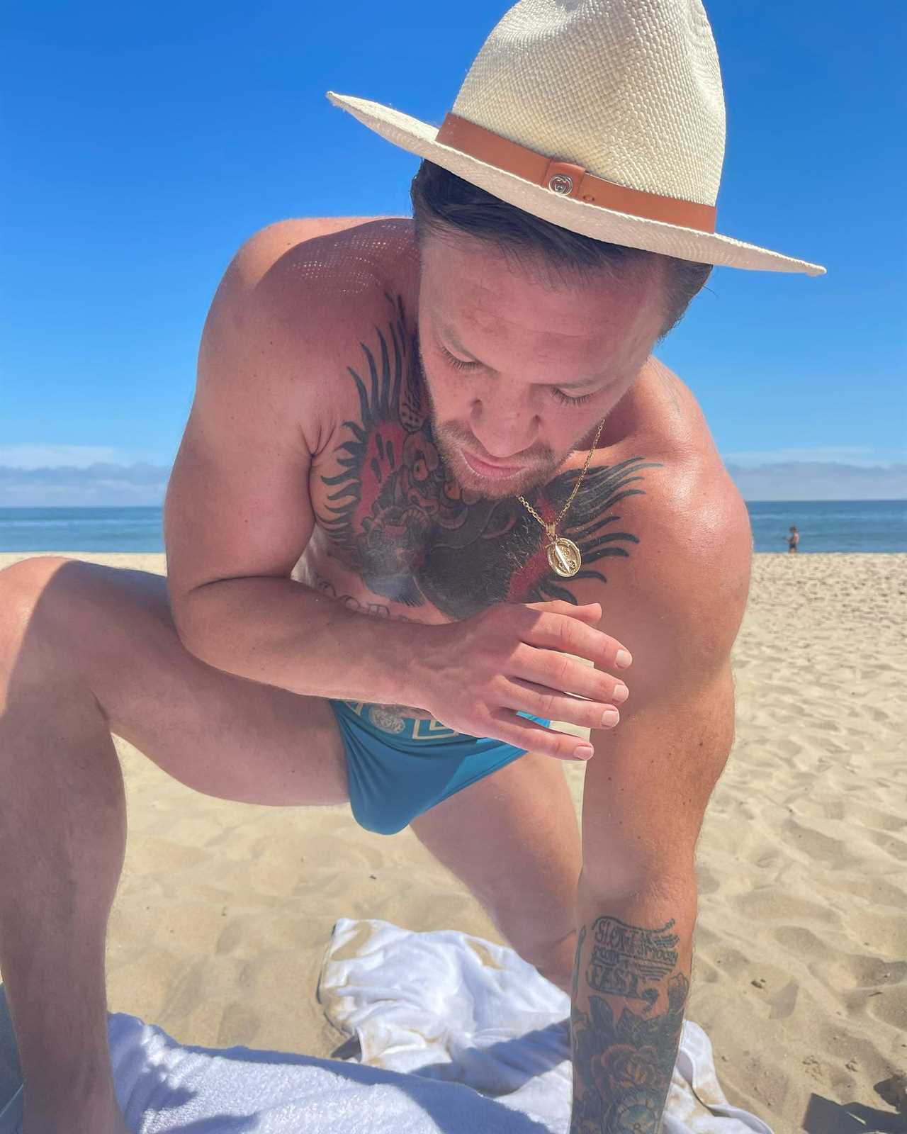Conor McGregor stretches with his budgiesmugglers while UFC icon Dee Devlin, pregnant and her children hit the beach.